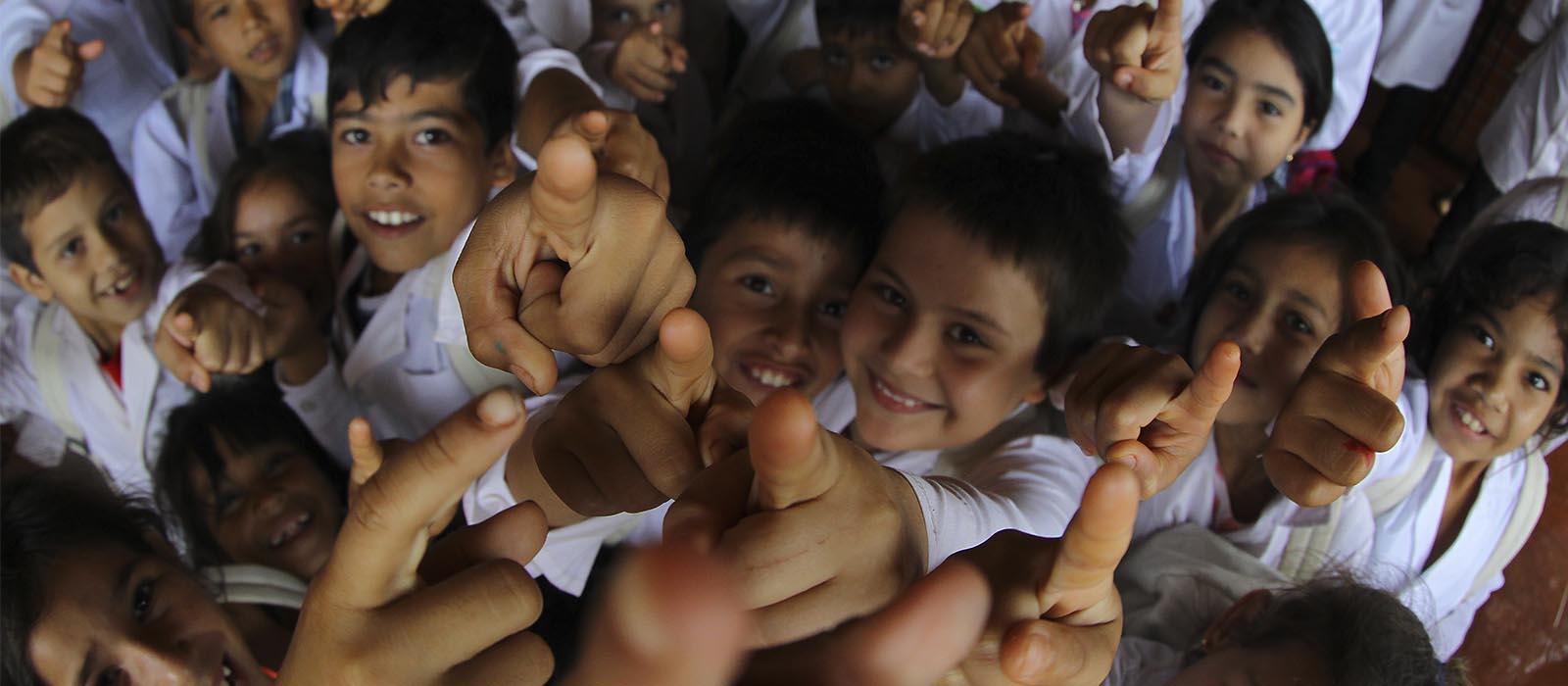 Group of children pointing at the camera Group of children pointing at the camera
